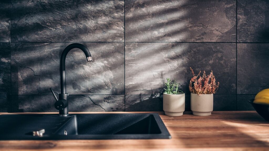 Kitchen with black slate wall tiles