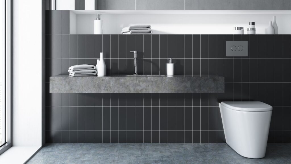 Bathroom that has black rectangular wall tiles and marble effect floor tiles